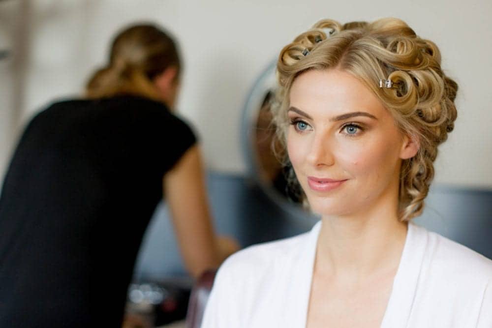 portrait of bride with hair in rollers and natural makeup