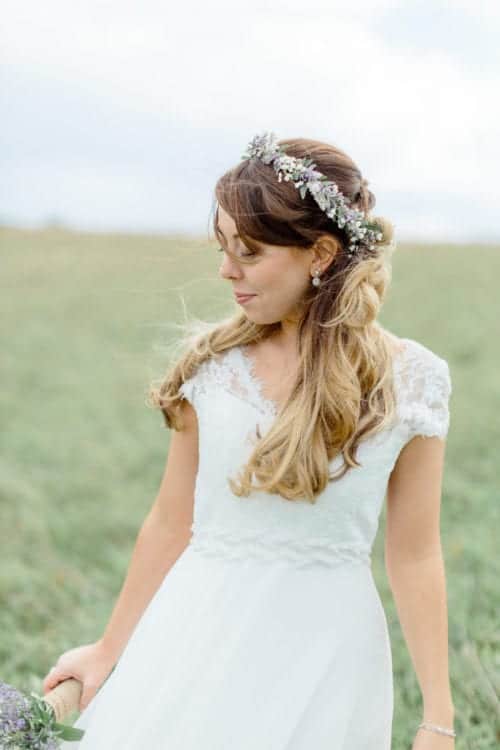 boho bride with flower crown in field