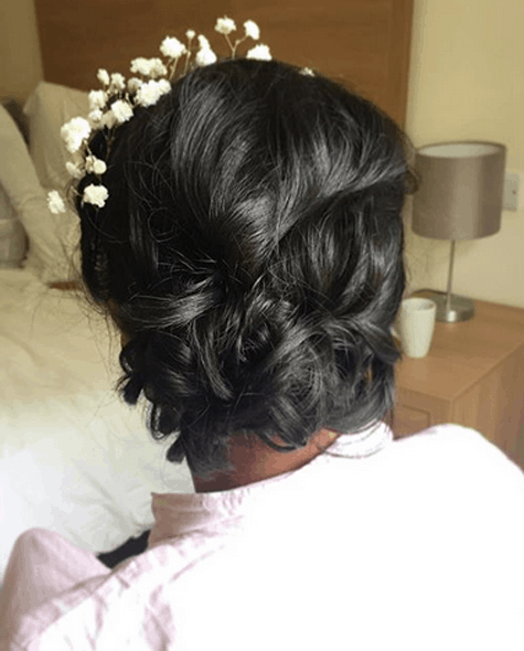 close up of loose bridal updo with baby&#039;s breath