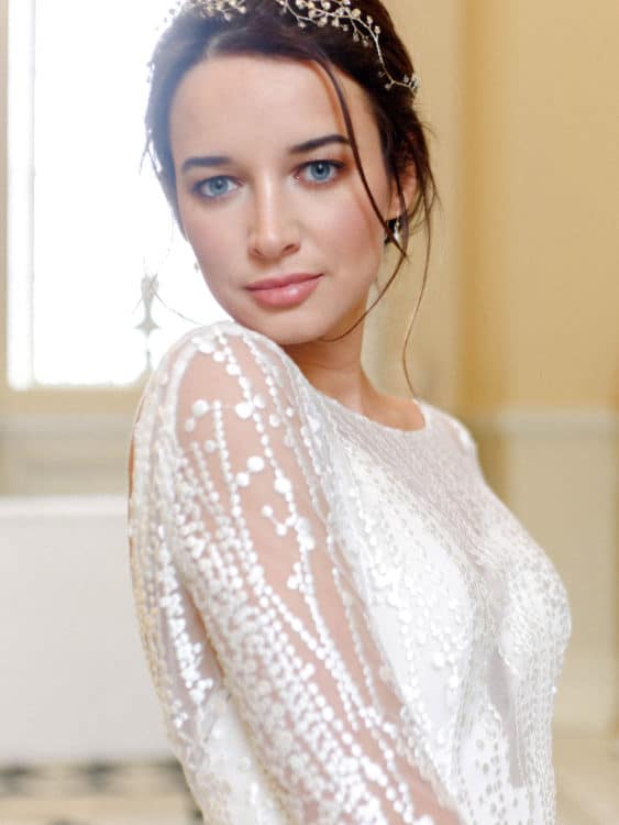 portrait of bride with natiral makeup and long sleeved wedding dress