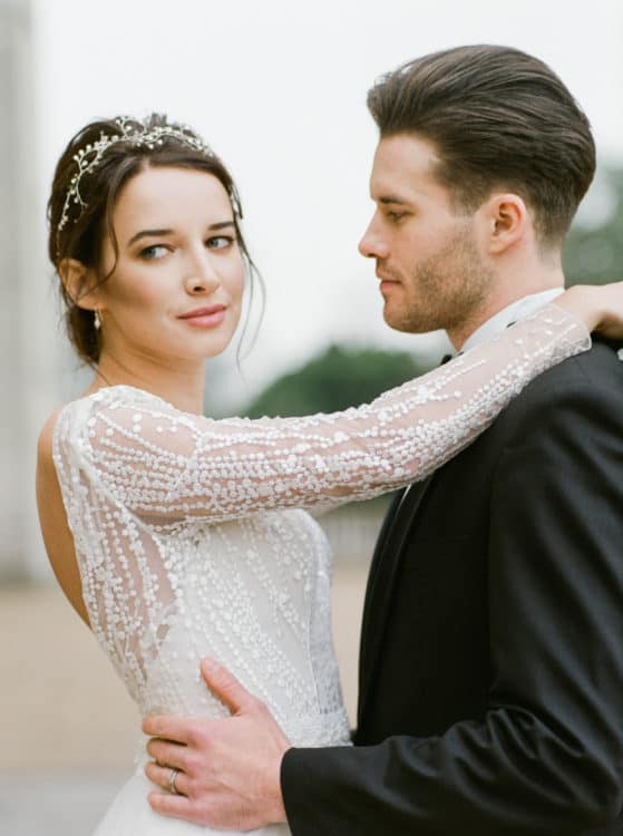 portrait of bride with long sleeved dress and groom